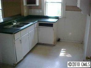 3916 Plainview Road Charlotte, NC 28208 - Photo 4 of 8 a kitchen with a sink and cabinets