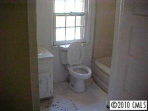 3916 Plainview Road Charlotte, NC 28208 - Photo 7 of 8 a white toilet sitting next to a bathroom sink