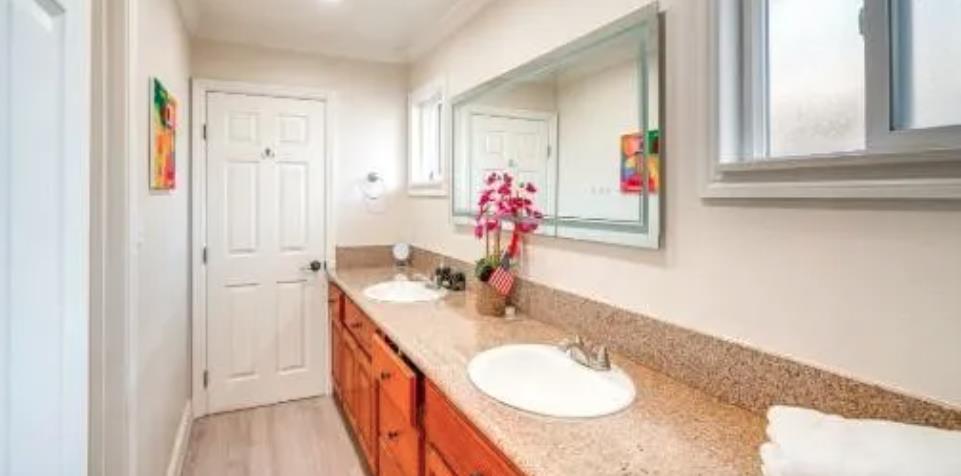 119 San Jose Street Salinas, CA 93901 - Photo 6 of 15 a en suite bathroom with a granite countertop double vanity and a mirror