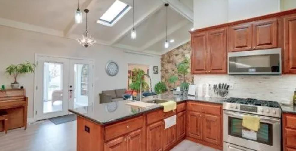 119 San Jose Street Salinas, CA 93901 - Photo 9 of 15 a kitchen with stainless steel appliances granite countertop a sink a stove oven a counter space and cabinets