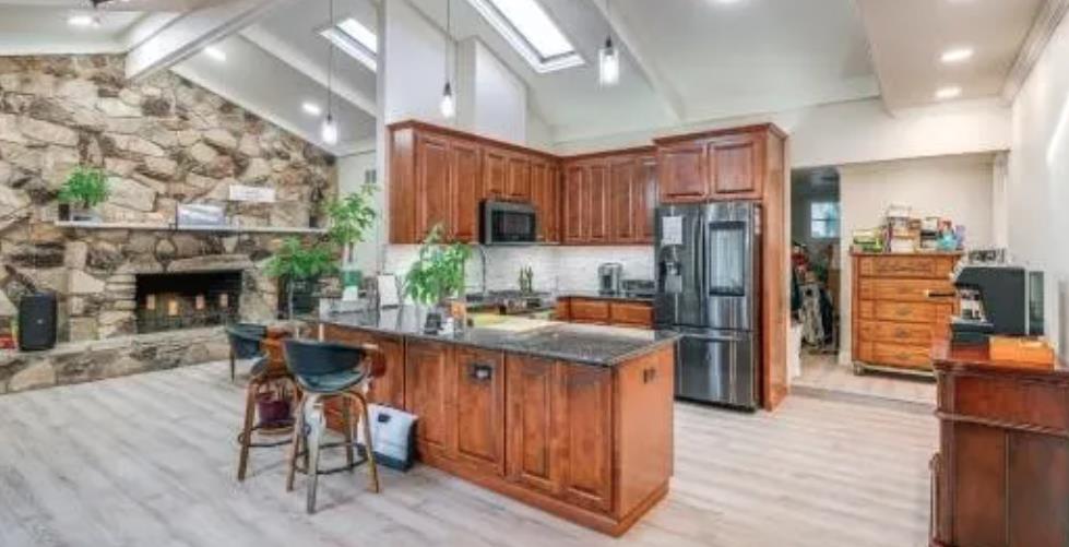 119 San Jose Street Salinas, CA 93901 - Photo 10 of 15 a kitchen with stainless steel appliances granite countertop a refrigerator a sink dishwasher a stove and a dining table with wooden floor