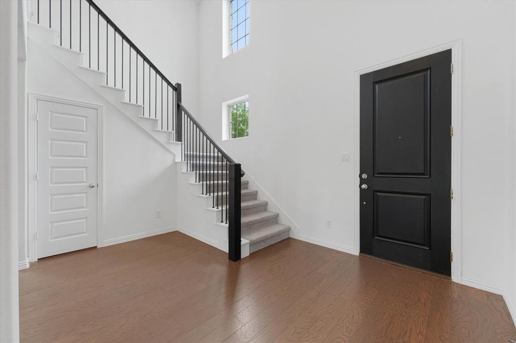 3533 Hyacinth Way Prosper, TX 75078 - Photo 5 of 38 a view of staircase with wooden floor and white walls