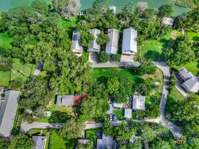 an aerial view of a house with outdoor space and street view