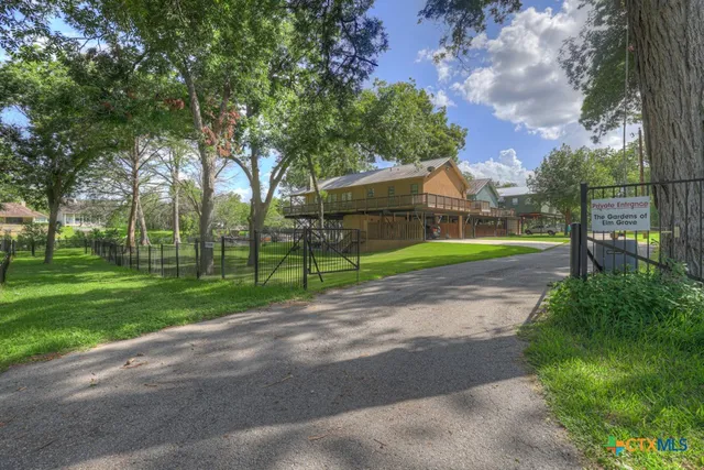 a view of a park with large trees and a big yard