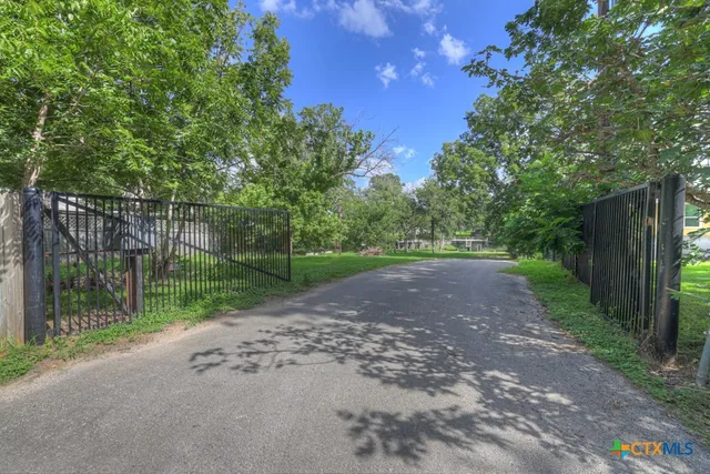 a view of a road with a small yard