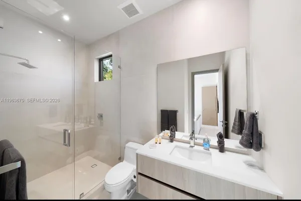 a bathroom with a sink toilet and shower