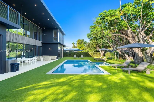 a view of yard with swimming pool and green space
