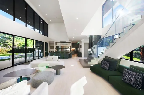 a dining room with furniture water view and a floor to ceiling window