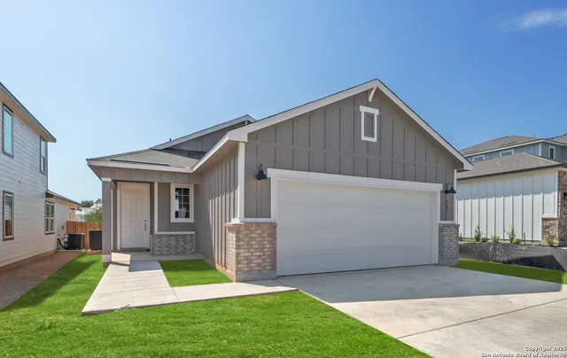 a view of backyard of house with wooden fence