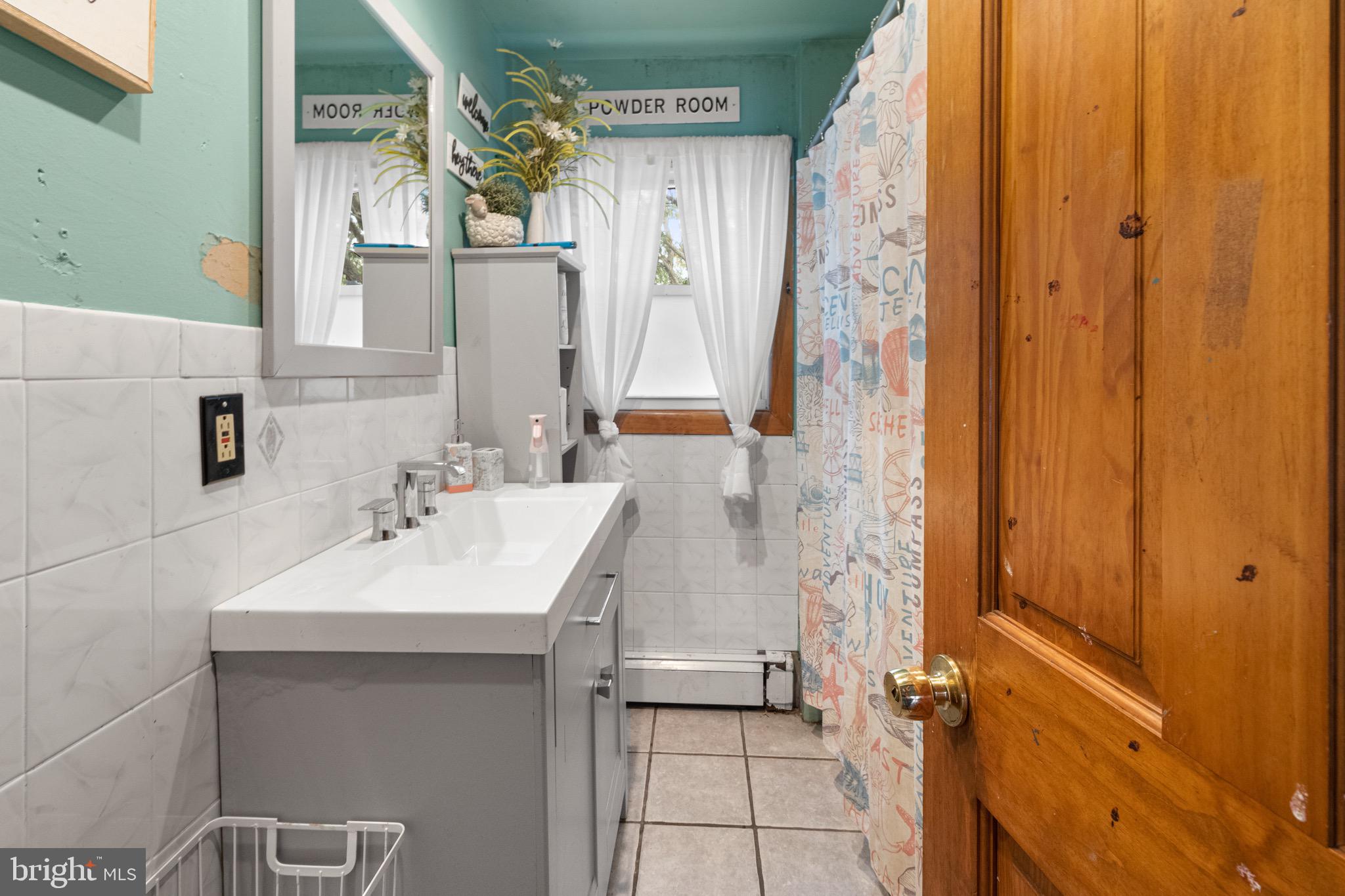 61 Franklin Avenue Clementon, NJ 08021 - Photo 19 of 32 a bathroom with a sink a mirror and a shower