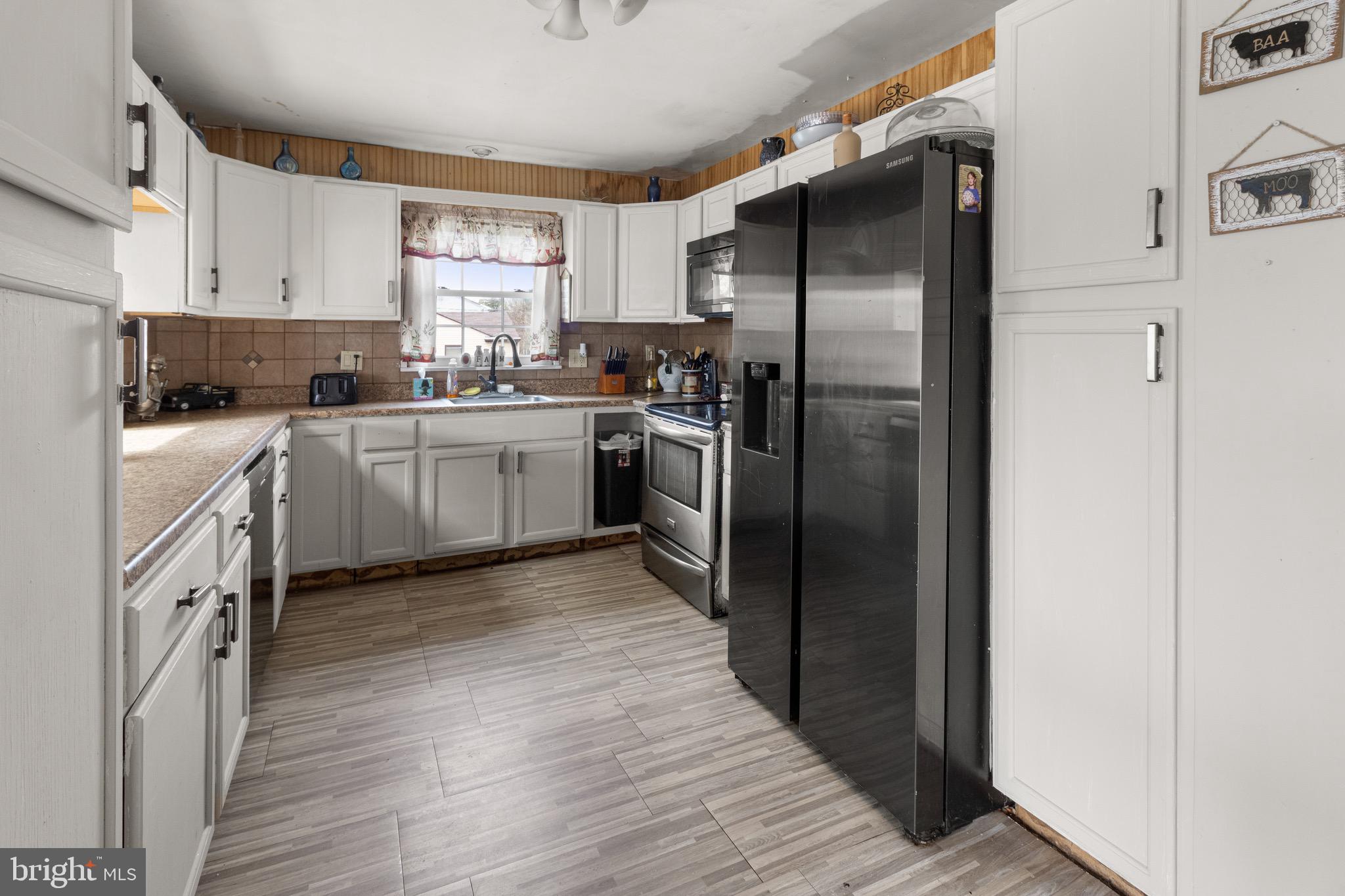 61 Franklin Avenue Clementon, NJ 08021 - Photo 20 of 32 a kitchen with a refrigerator sink and wooden floor