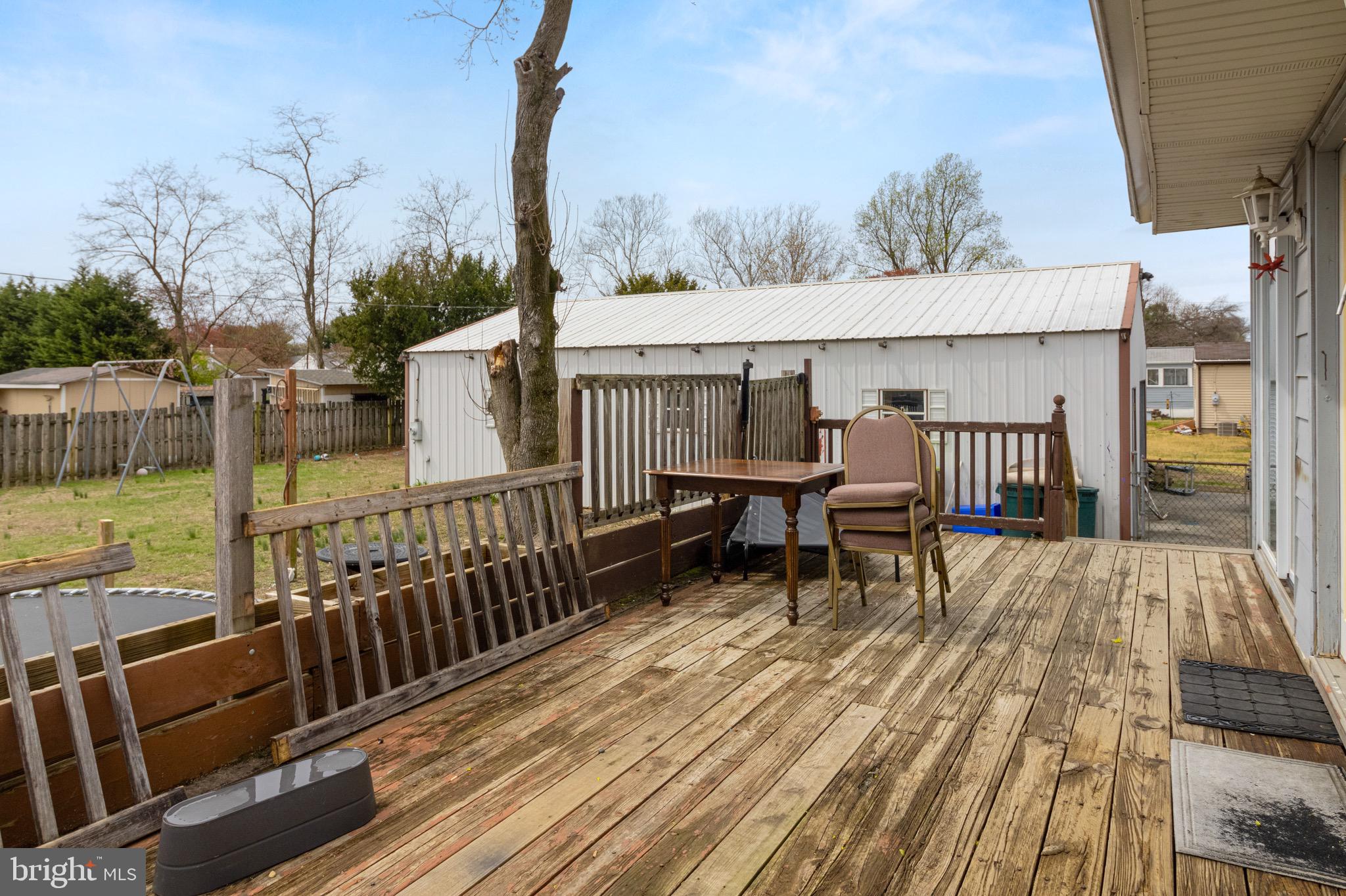 61 Franklin Avenue Clementon, NJ 08021 - Photo 27 of 32 a view of a roof deck with table and chairs wooden floor and fence