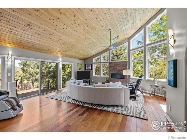 a living room with furniture large window and outer view