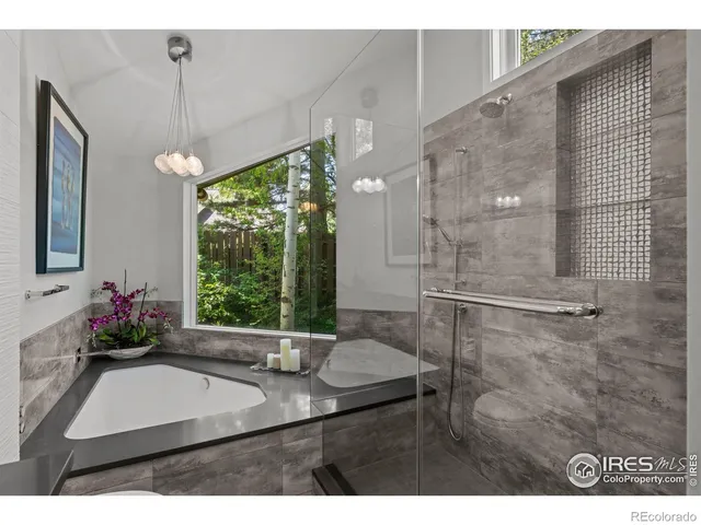 a bathroom with a sink mirror and a shower