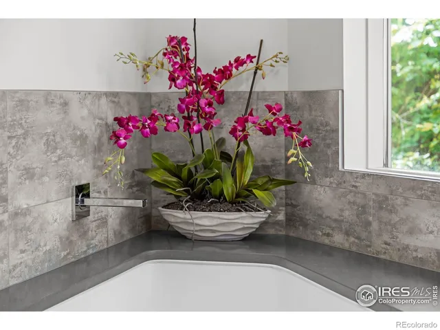 a dining room with furniture and flowers