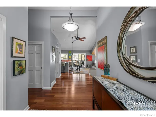a view of a dining room with furniture a chandelier and wooden floor