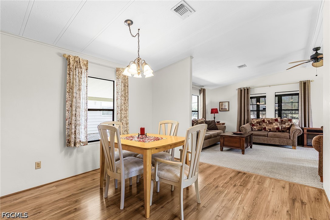 5 Erica Street Alva, FL 33920 - Photo 21 of 37 a view of a dining room with furniture window and wooden floor