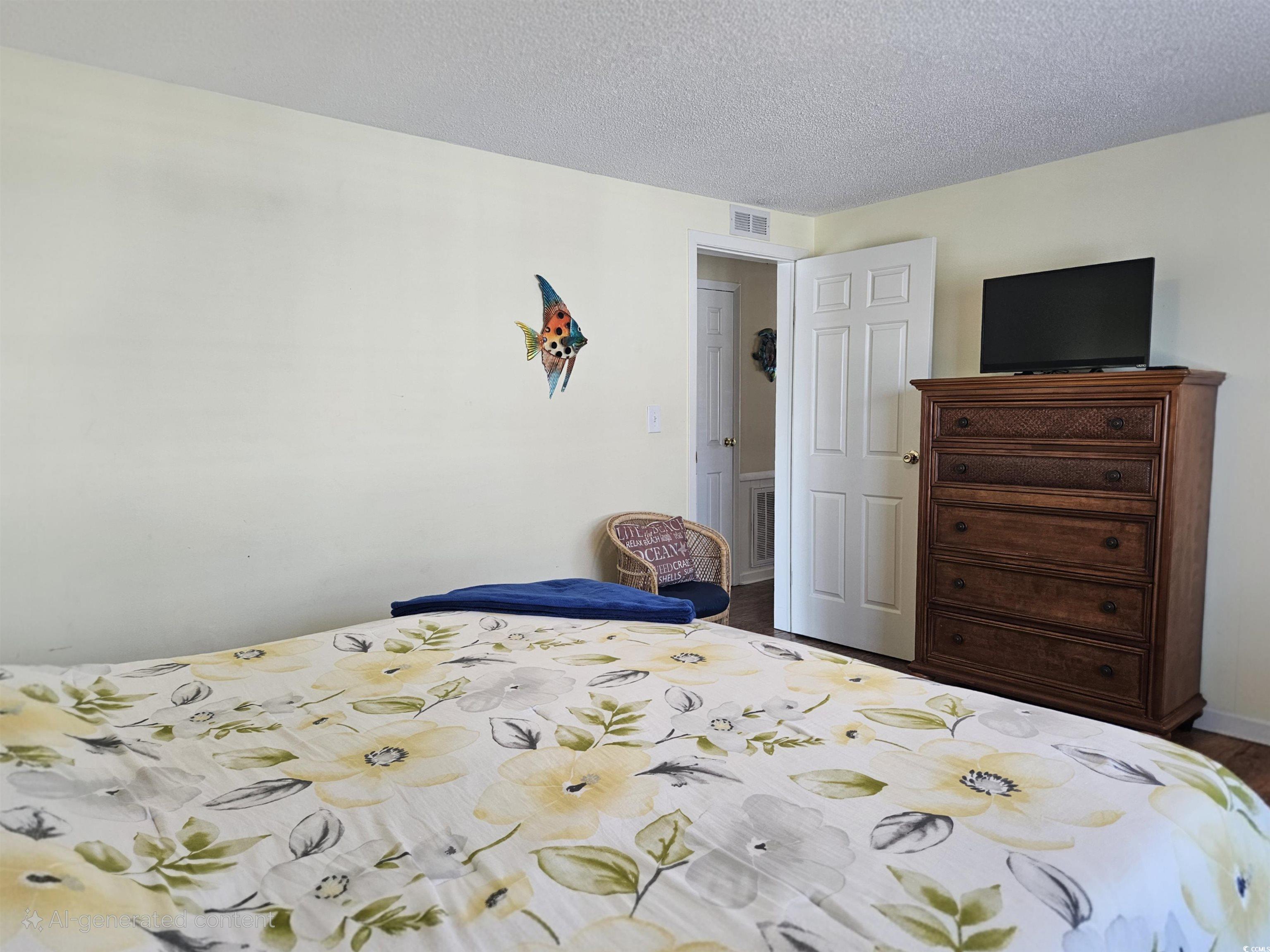 1981 Morning Glory Surfside Beach, SC 29575 - Photo 11 of 22 Bedroom featuring a textured ceiling and wood finished floors
