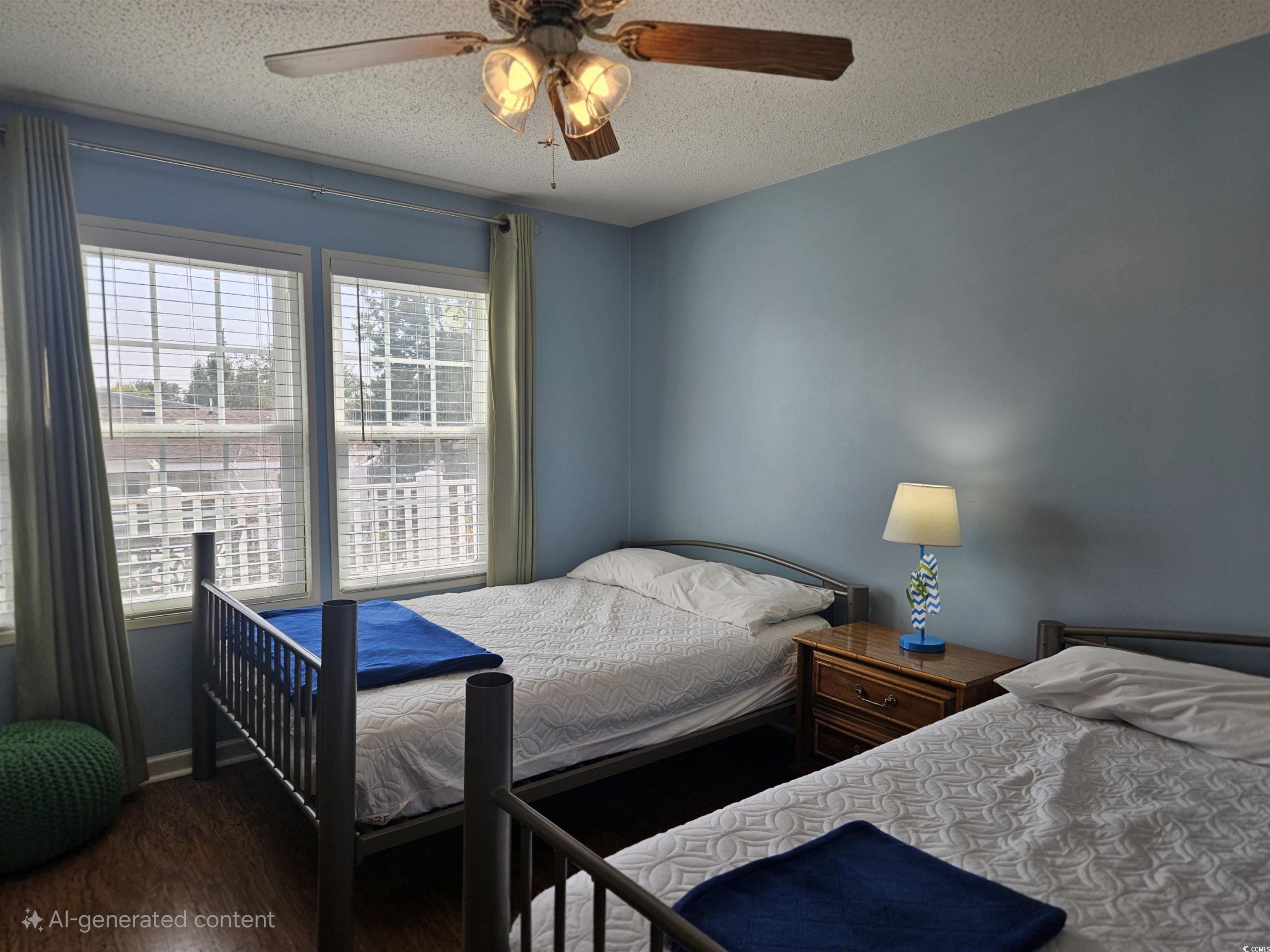 1981 Morning Glory Surfside Beach, SC 29575 - Photo 13 of 22 Bedroom with dark wood-style flooring, a textured ceiling, and ceiling fan