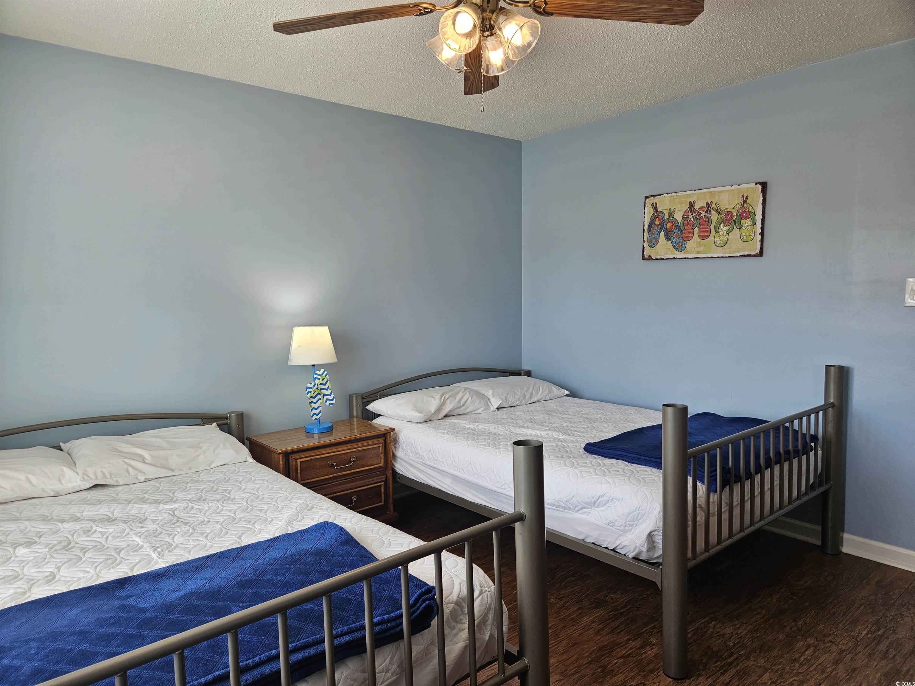 1981 Morning Glory Surfside Beach, SC 29575 - Photo 14 of 22 Bedroom with a textured ceiling, dark wood finished floors, and a ceiling fan