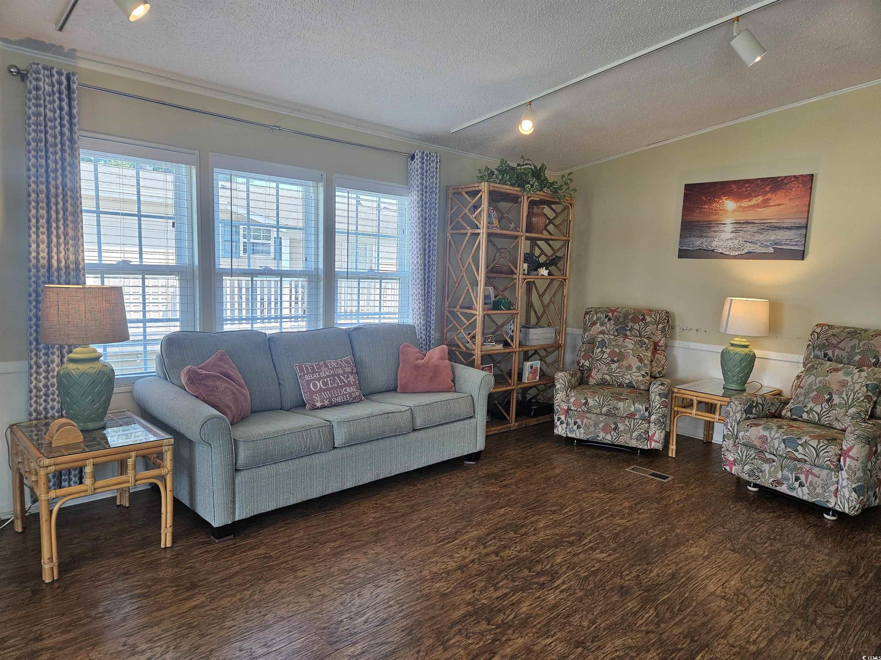 1981 Morning Glory Surfside Beach, SC 29575 - Photo 8 of 22 Living room featuring rail lighting, a textured ceiling, wood finished floors, lofted ceiling, and crown molding
