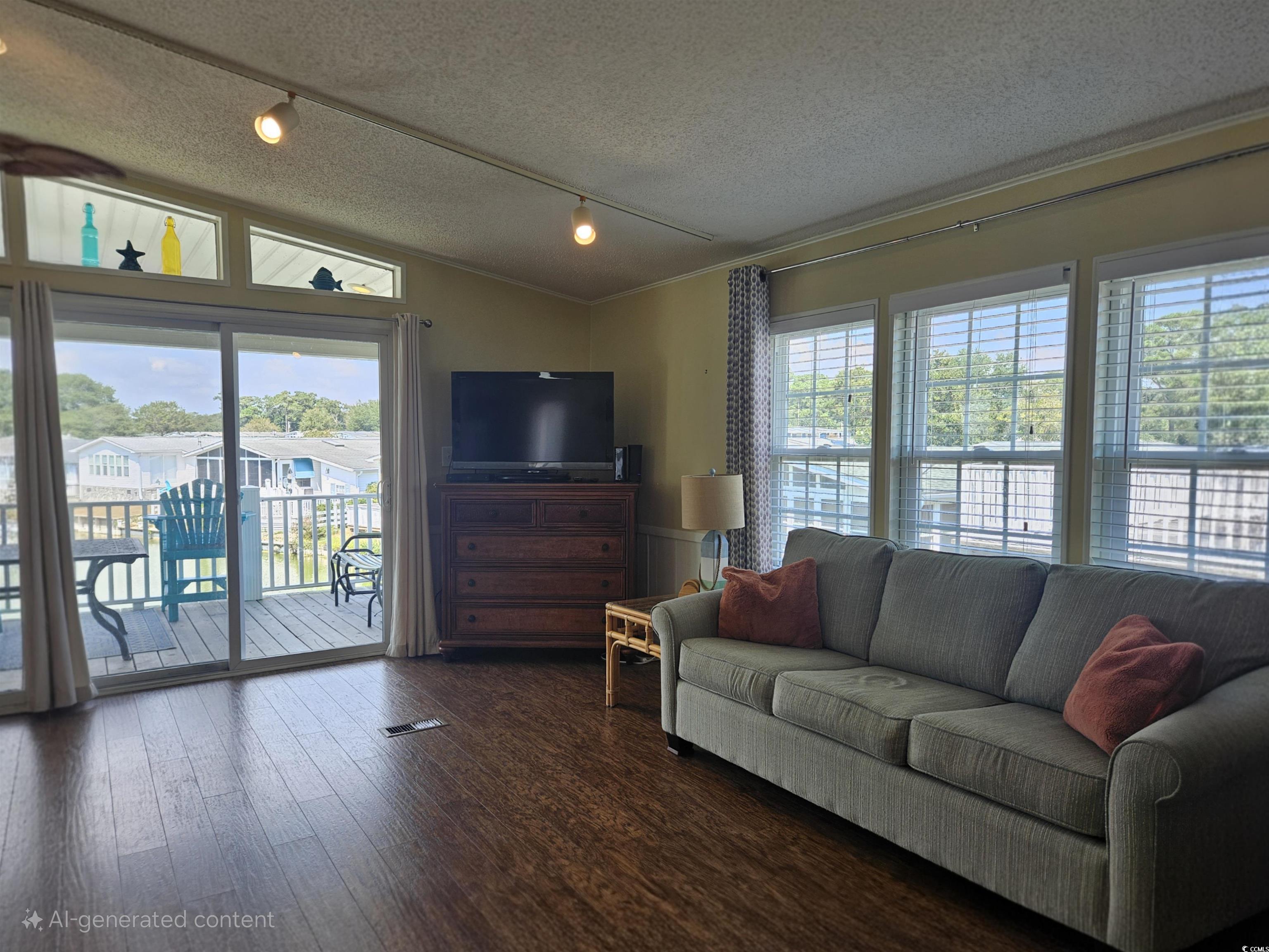 1981 Morning Glory Surfside Beach, SC 29575 - Photo 9 of 22 Living room featuring rail lighting, a textured ceiling, wood finished floors, and lofted ceiling