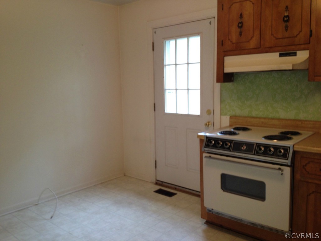 10531 Genlou Road Chesterfield, VA 23832 - Photo 5 of 17 a kitchen with a stove and a microwave