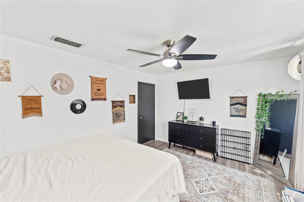 338 HCR 2124 Loop Whitney, TX 76692 - Photo 21 of 39 a bedroom with a bed and a flat screen tv