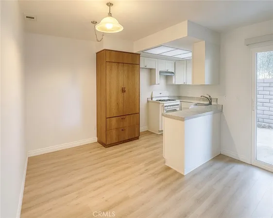 a kitchen with granite countertop a stove and a refrigerator