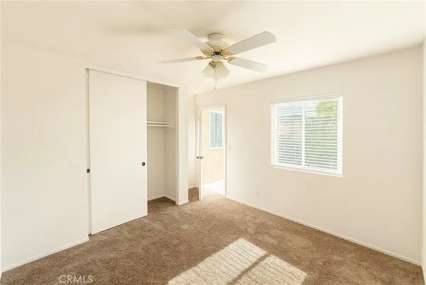 a view of a livingroom with a ceiling fan and window