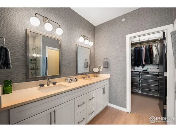 a bathroom with a double vanity sink and a mirror