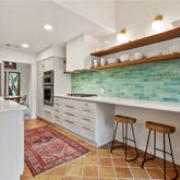 a kitchen with stainless steel appliances granite countertop a sink and a wooden cabinets