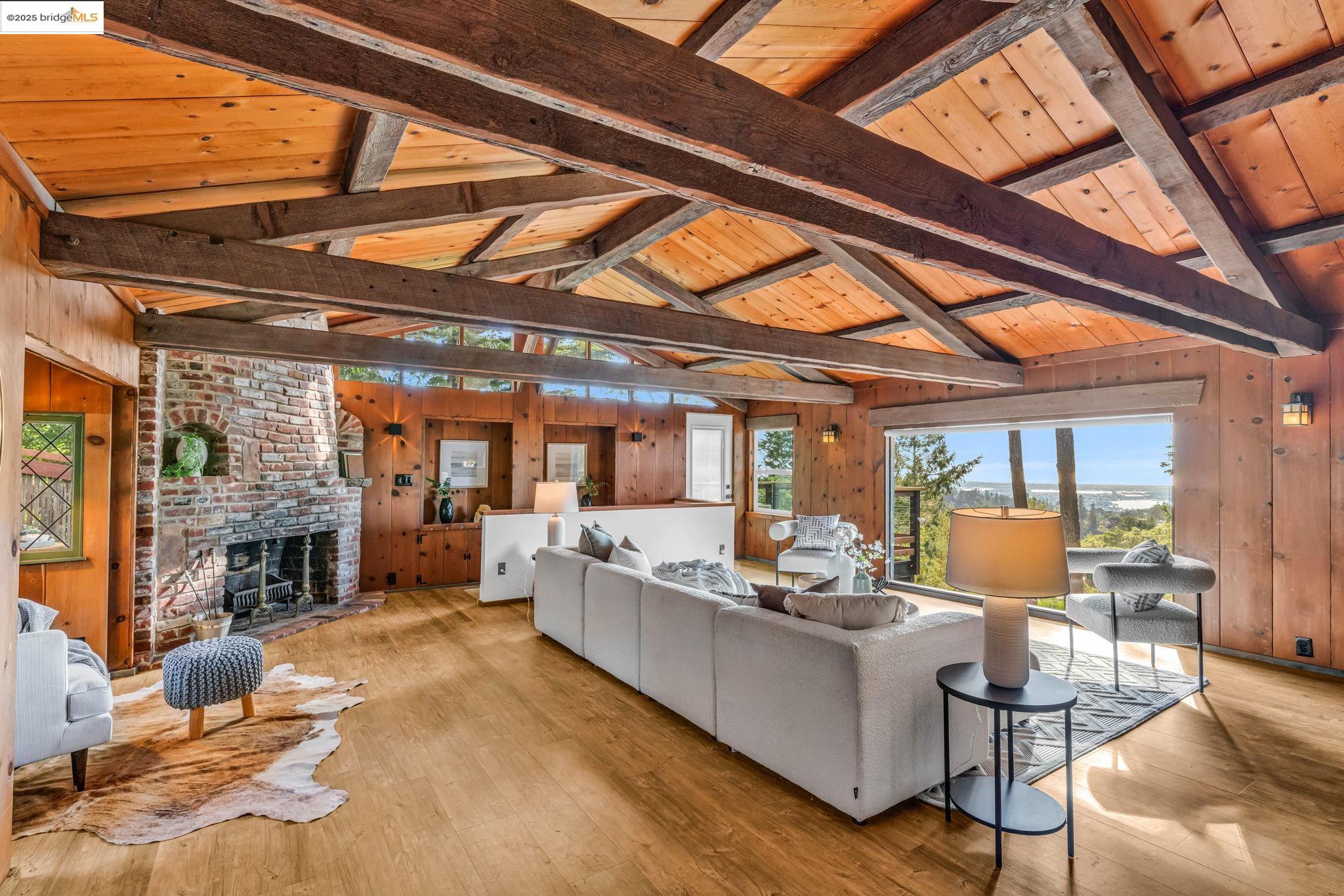 6141 Merriewood Drive Oakland, CA 94611 - Photo 11 of 58 a living room with fireplace furniture and a floor to ceiling window
