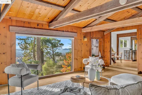 a view of a dining room with furniture and a window