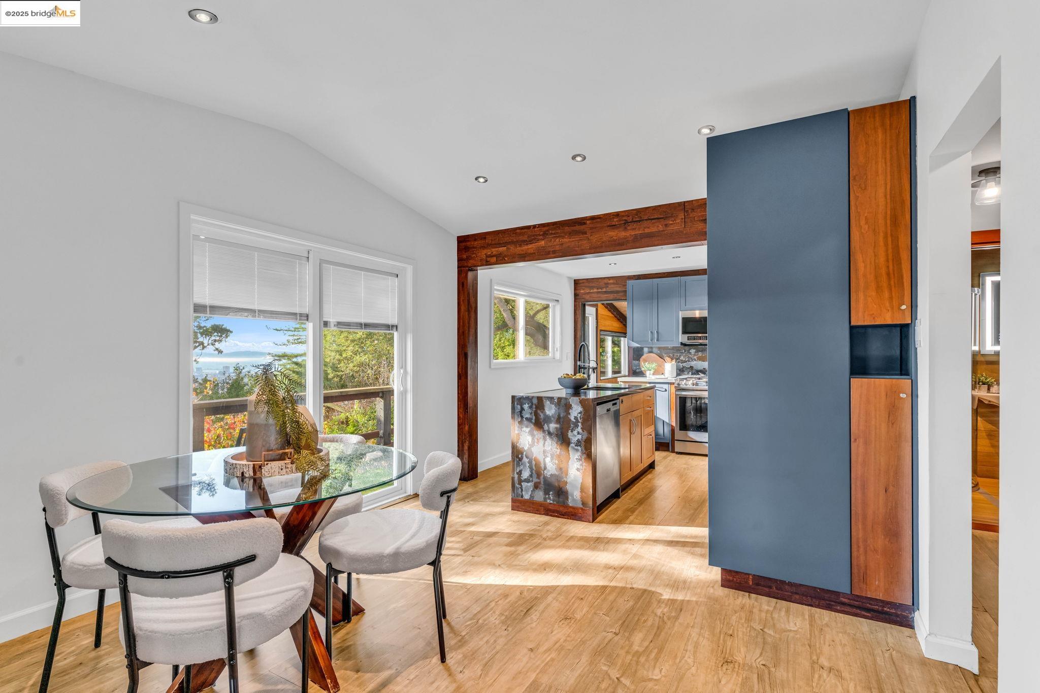 6141 Merriewood Drive Oakland, CA 94611 - Photo 17 of 58 a view of a dining room with furniture and a window