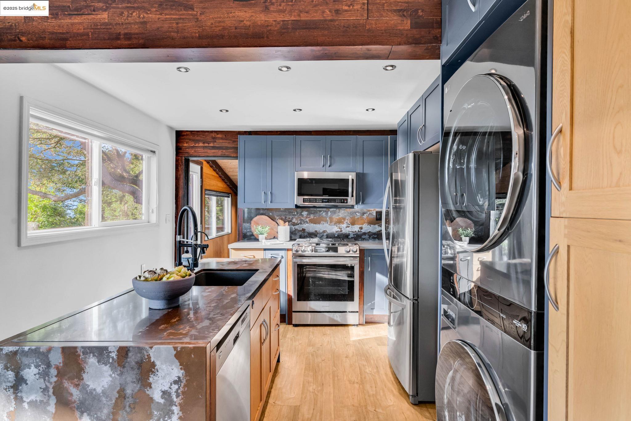 6141 Merriewood Drive Oakland, CA 94611 - Photo 18 of 58 a kitchen with stainless steel appliances granite countertop a stove a sink and a refrigerator