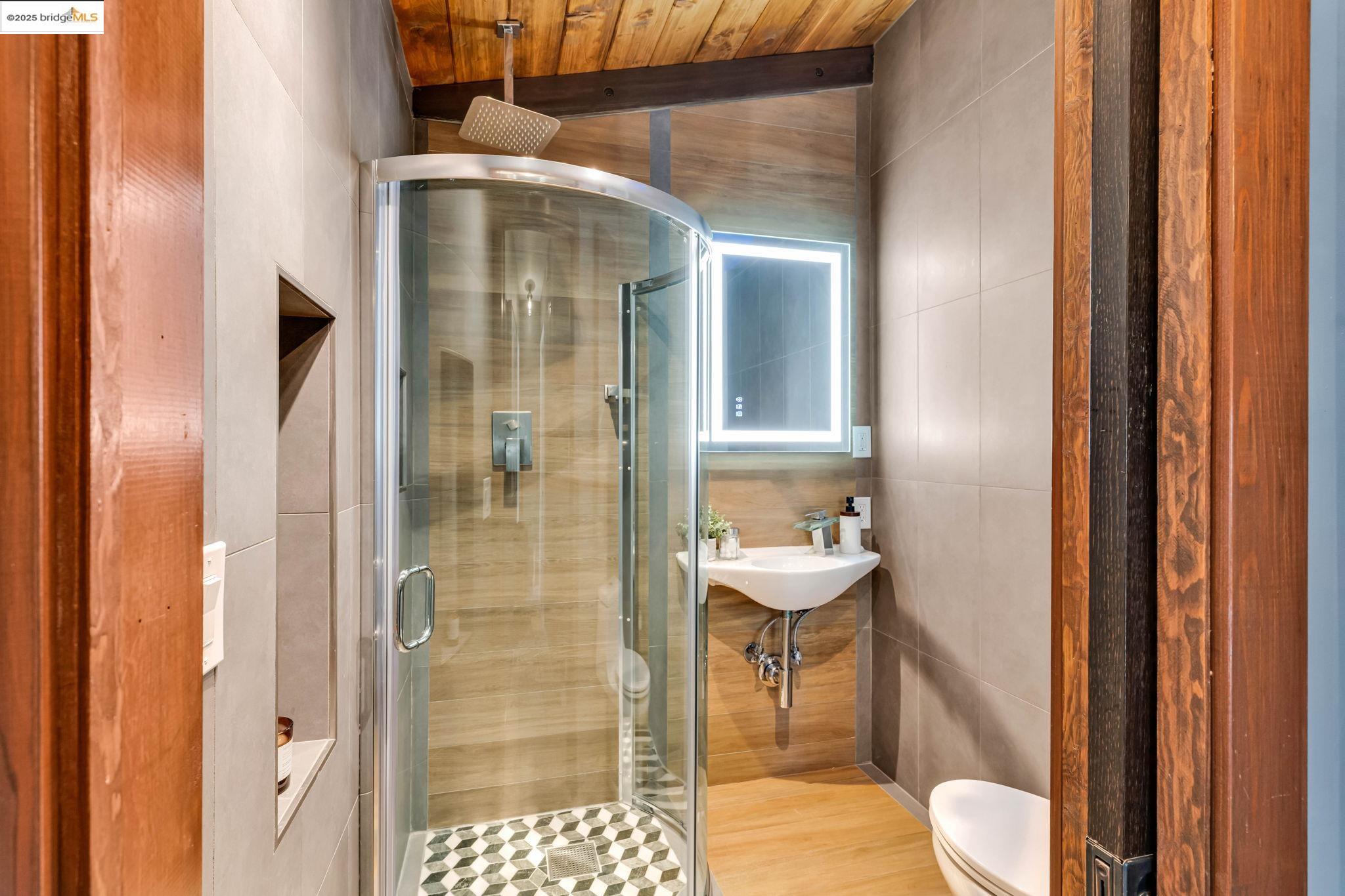 6141 Merriewood Drive Oakland, CA 94611 - Photo 22 of 58 a bathroom with a toilet and a sink