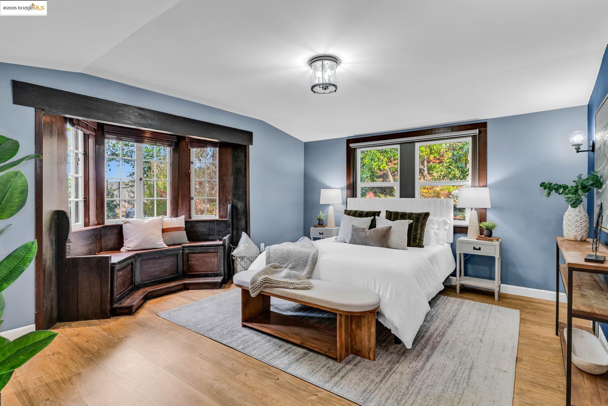 6141 Merriewood Drive Oakland, CA 94611 - Photo 23 of 58 a bedroom with a bed and large window