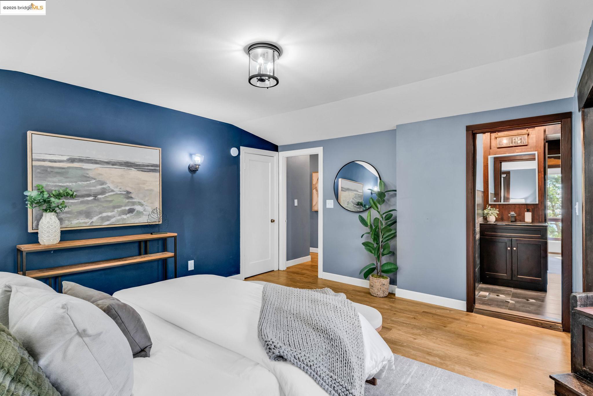 6141 Merriewood Drive Oakland, CA 94611 - Photo 24 of 58 a bedroom with a bed and a chandelier