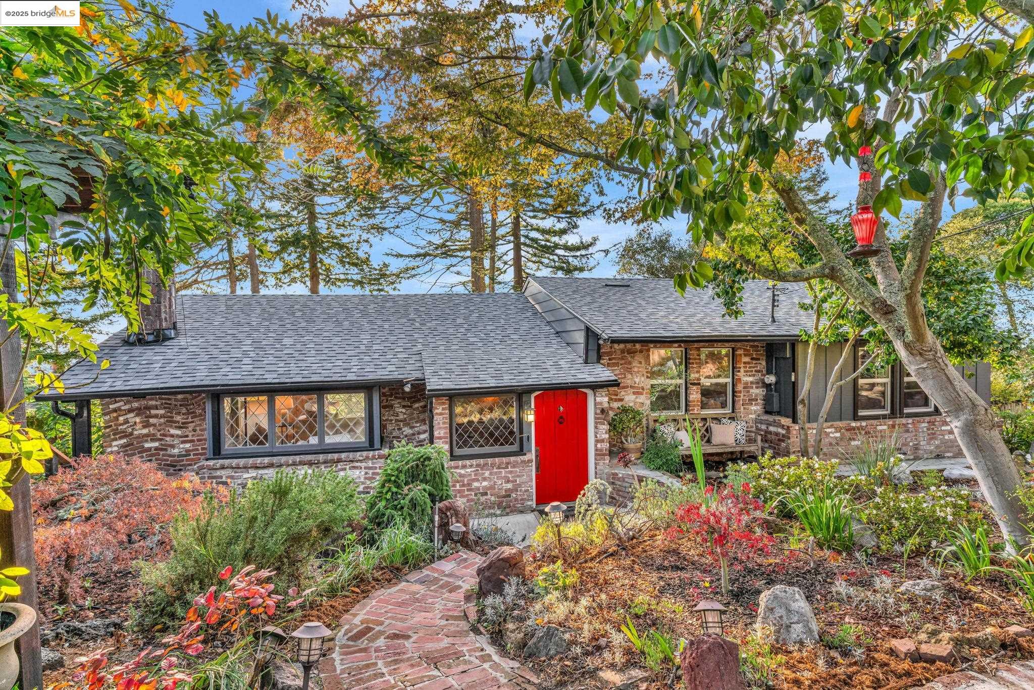 6141 Merriewood Drive Oakland, CA 94611 - Photo 3 of 58 a front view of a house with a yard and tree