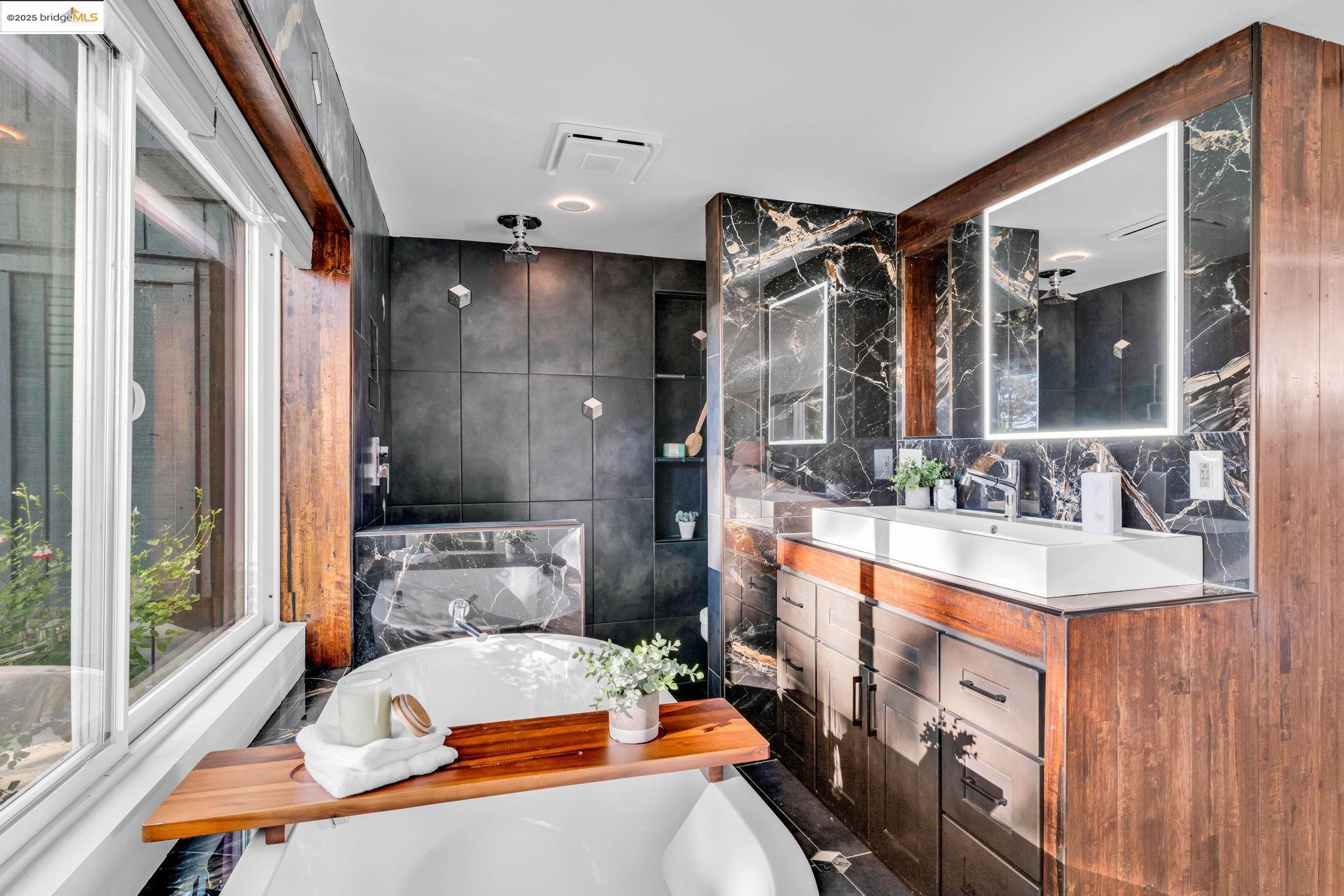 6141 Merriewood Drive Oakland, CA 94611 - Photo 33 of 58 a bathroom with a tub sink and mirror