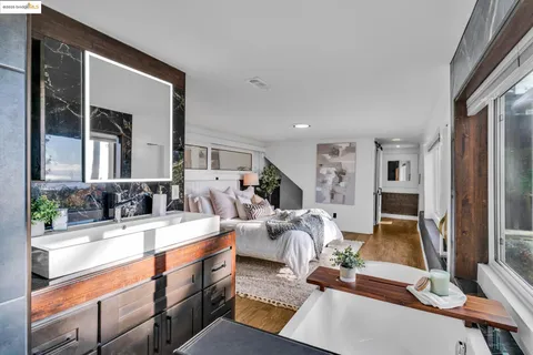 a view of bathroom with washing machine and mirror