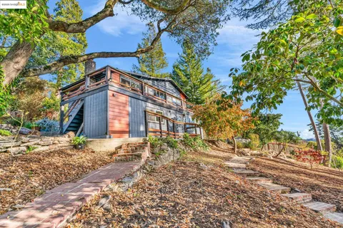 a backyard of a building with large trees