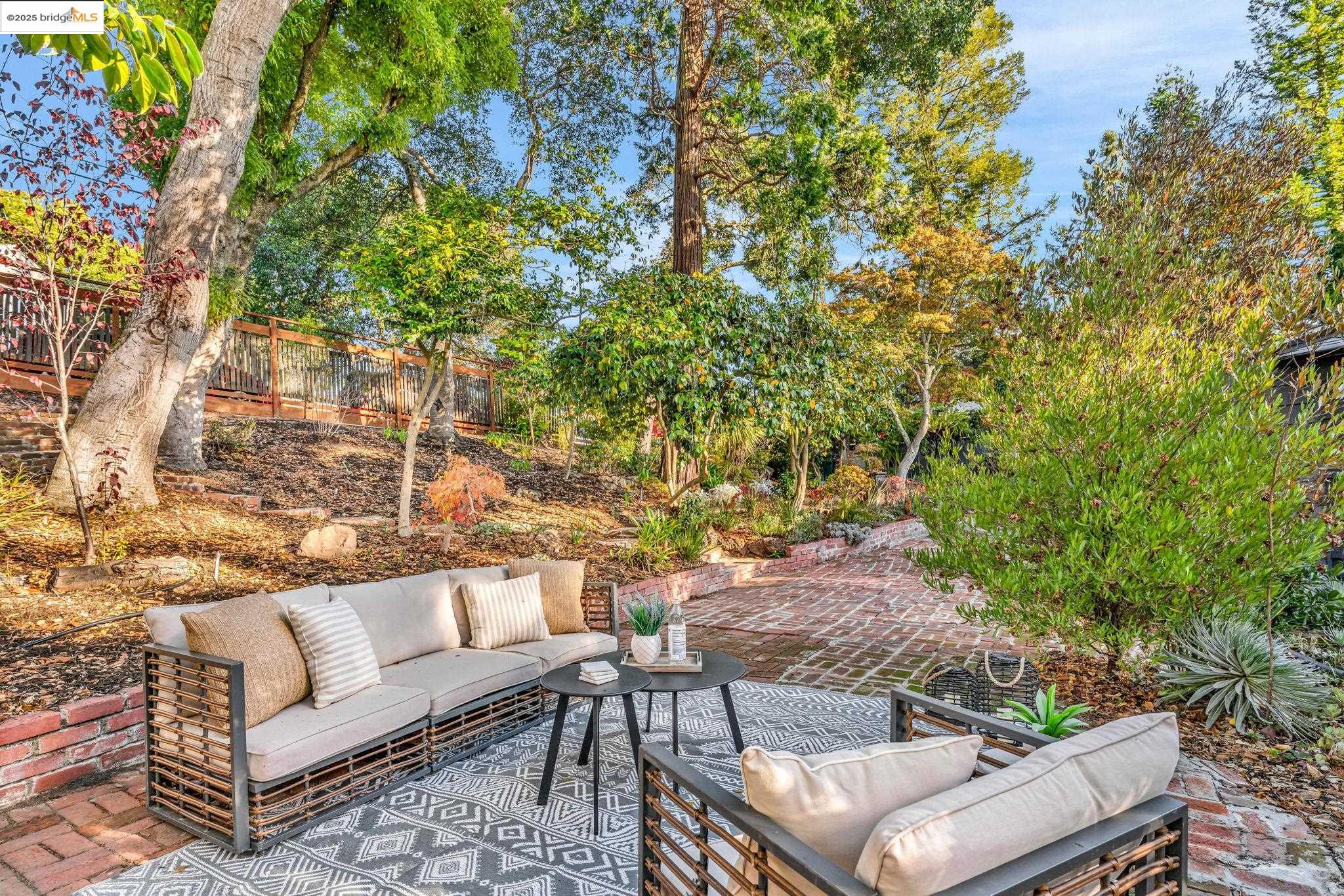6141 Merriewood Drive Oakland, CA 94611 - Photo 49 of 58 a view of a patio with couches and a large tree