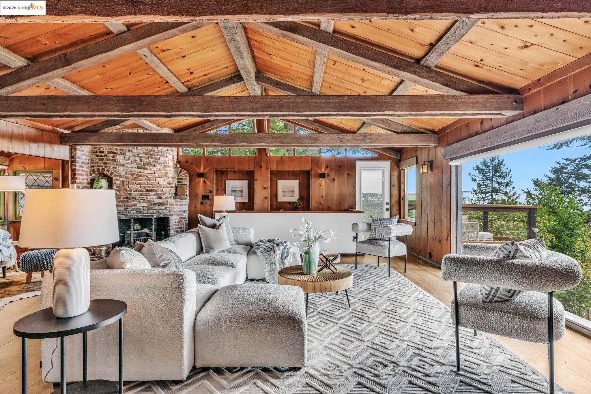 6141 Merriewood Drive Oakland, CA 94611 - Photo 7 of 58 a living room with furniture a fireplace and a table
