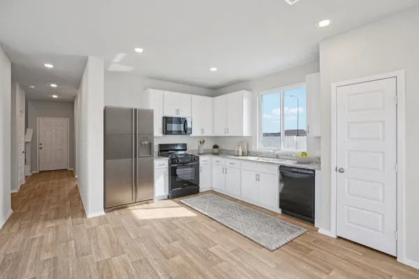 a kitchen with a refrigerator and a sink