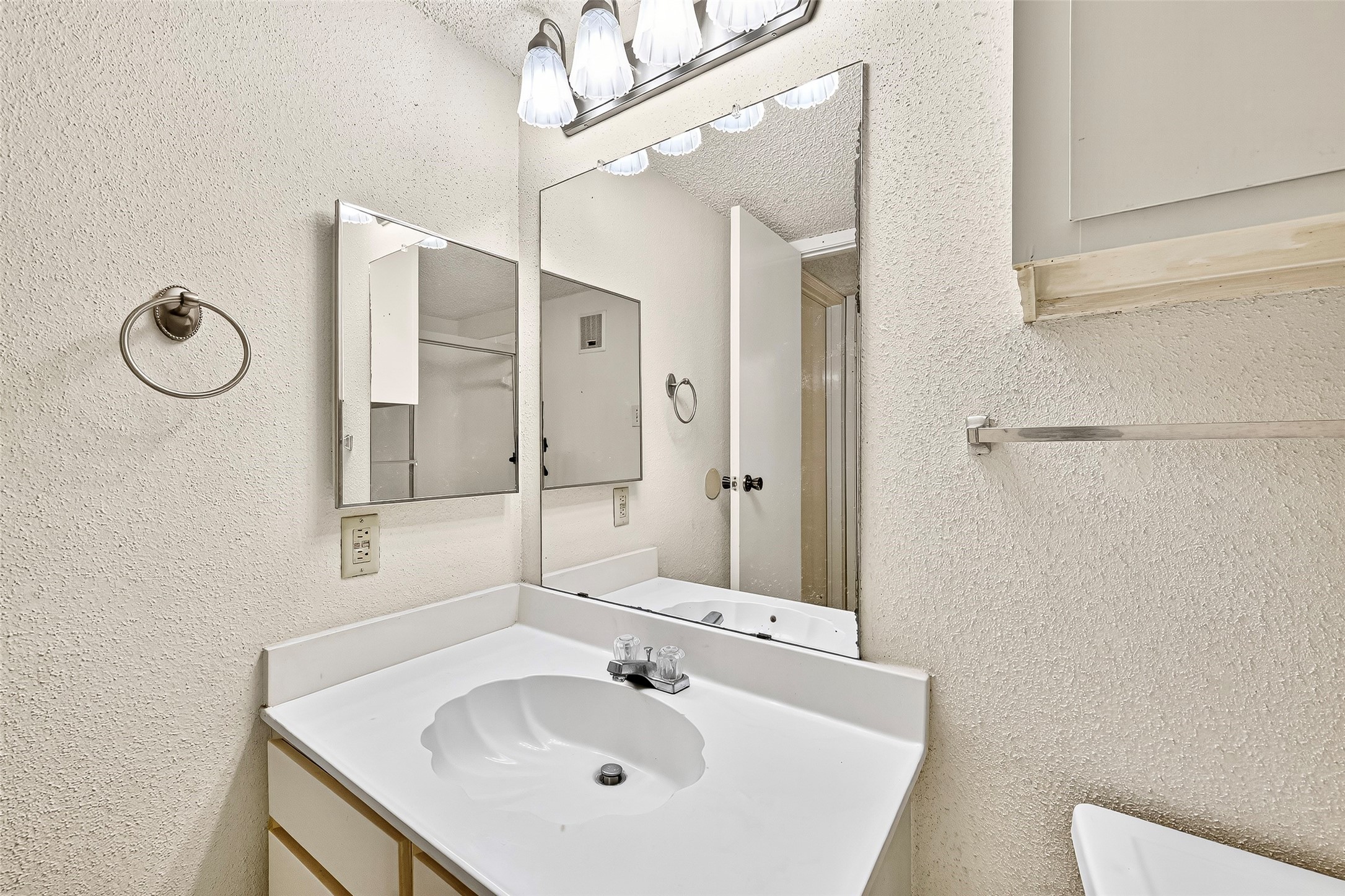 1515 Sandy Springs Road, Unit 3001 Houston, TX 77042 - Photo 16 of 28 a bathroom with a sink a toilet and a mirror