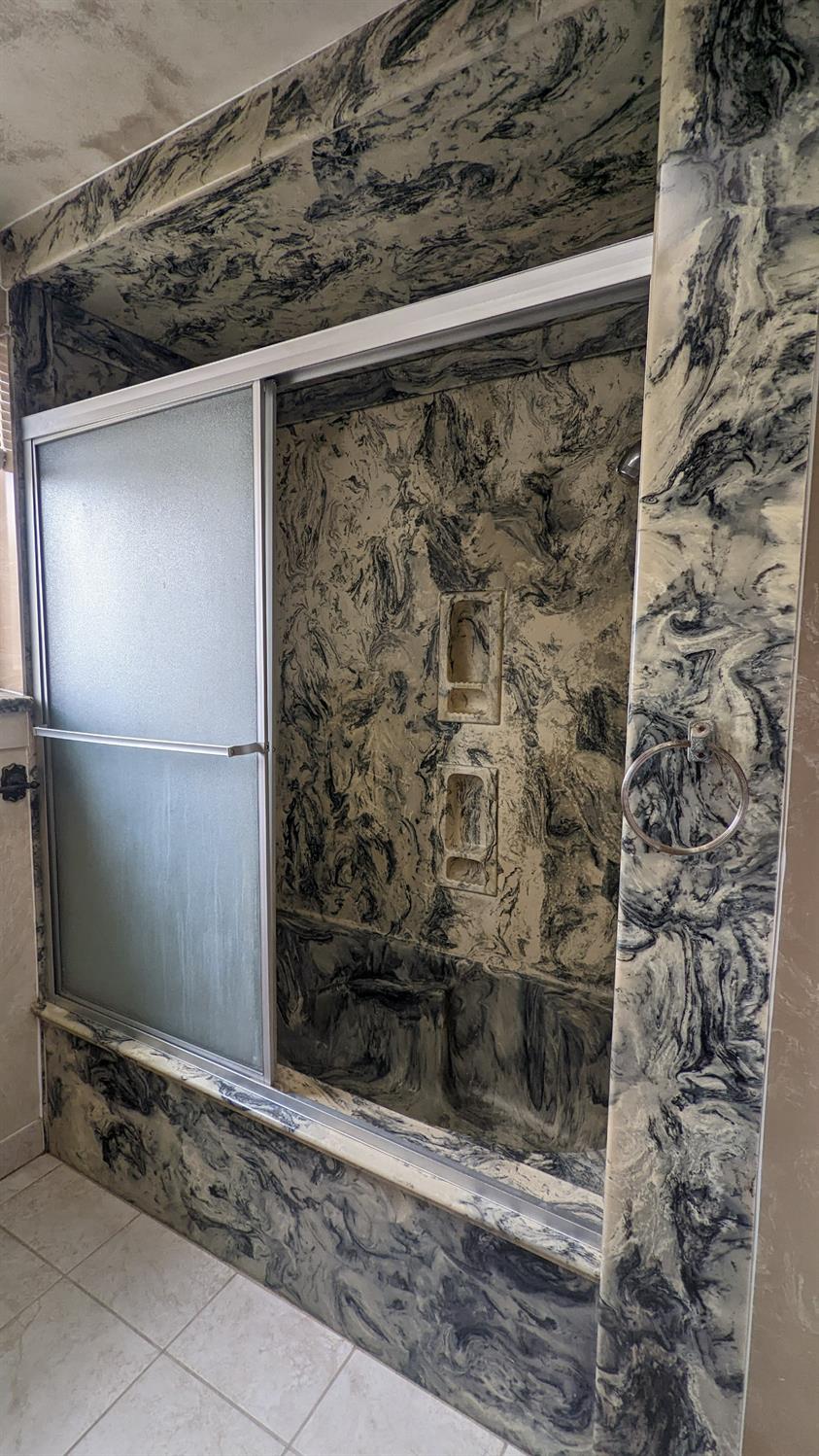 930 Sierra Street Madera, CA 93638 - Photo 11 of 16 a bathroom with a glass door shower