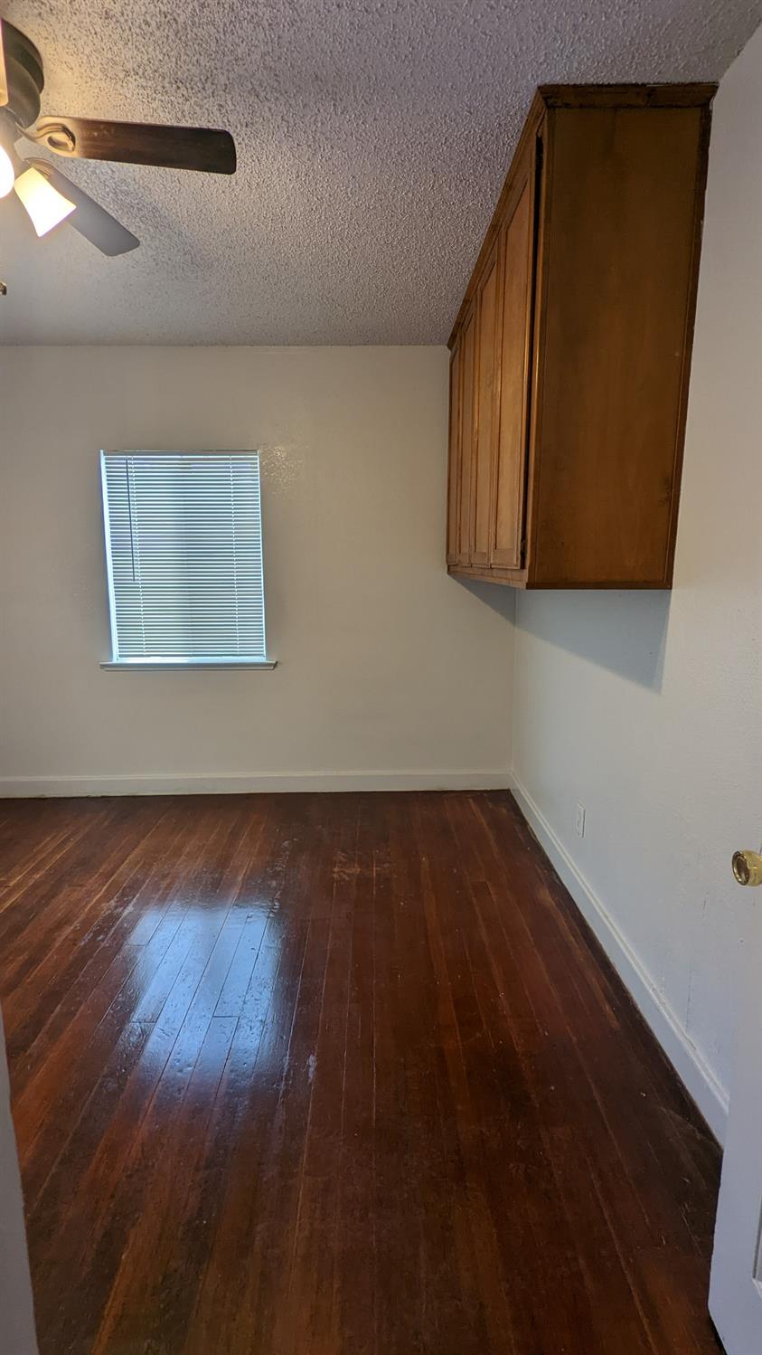 930 Sierra Street Madera, CA 93638 - Photo 13 of 16 a view of a room with wooden floor and cabinet