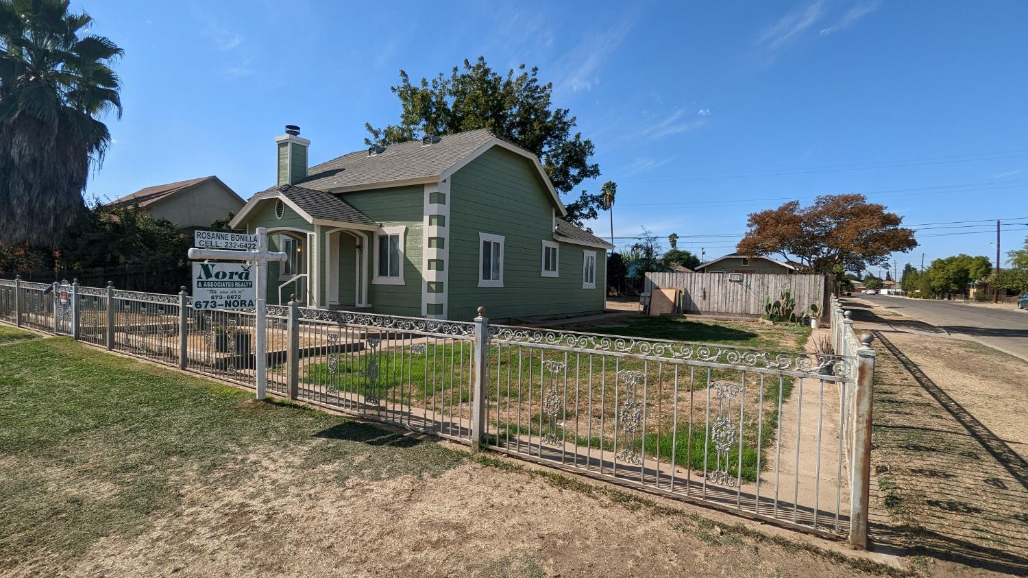 930 Sierra Street Madera, CA 93638 - Photo 2 of 16 a front view of house with wooden fence
